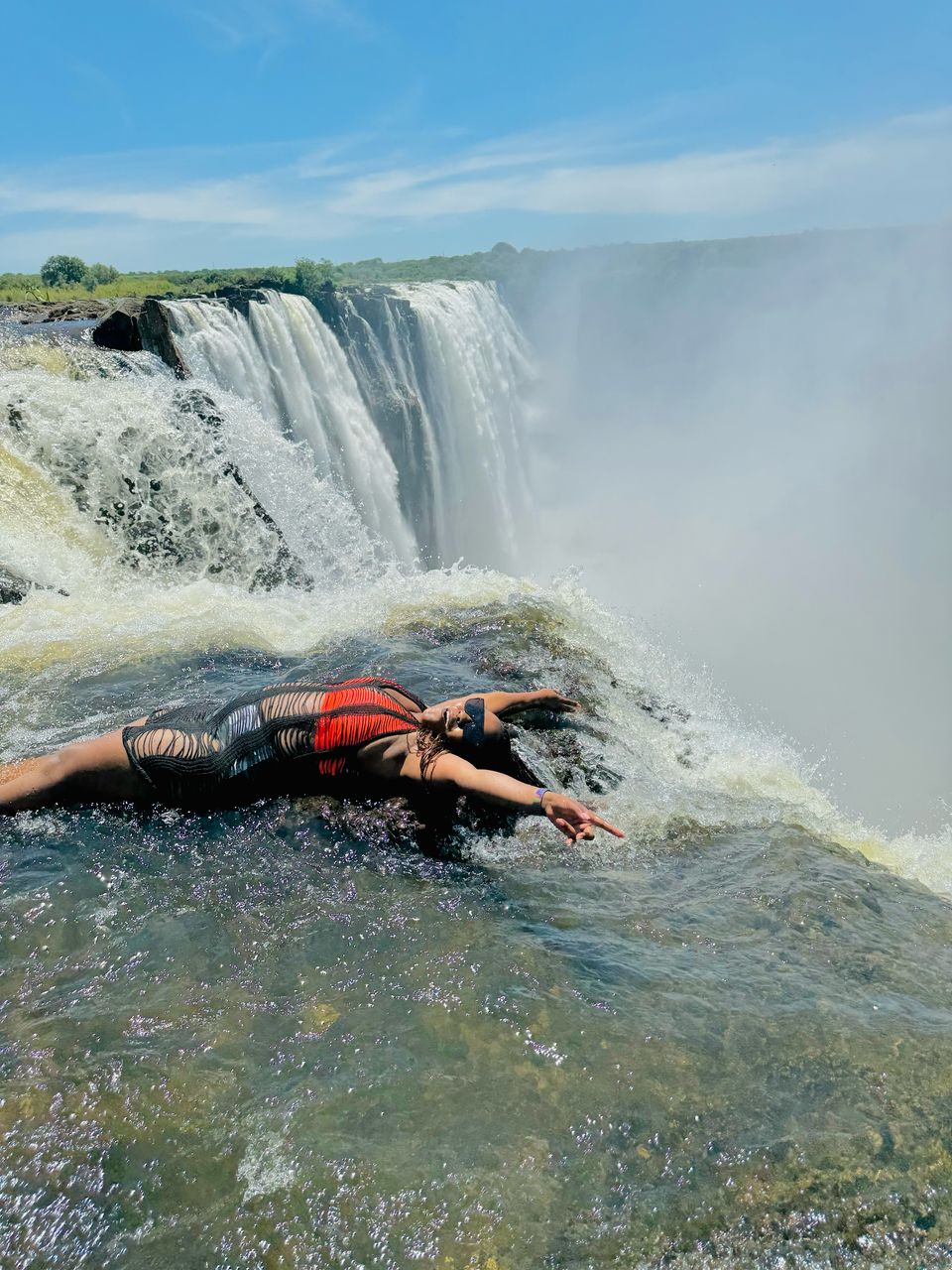 Swimmer at Devil's Pool on the edge of Victoria Falls