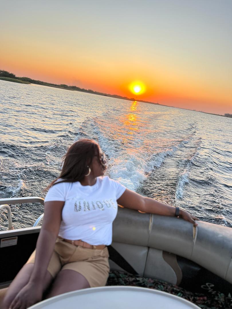 Guest watching the sunset from a Zambezi river cruise boat